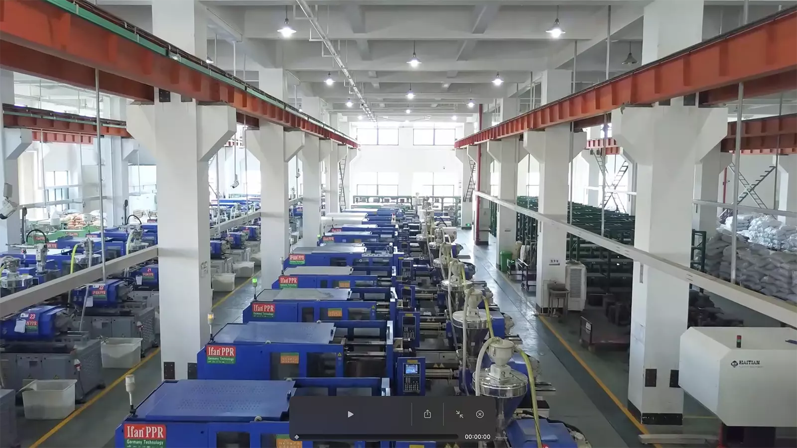 Rows of injection moulding machines running in the IFANPRO factory where HDPE and PPR fittings are produced