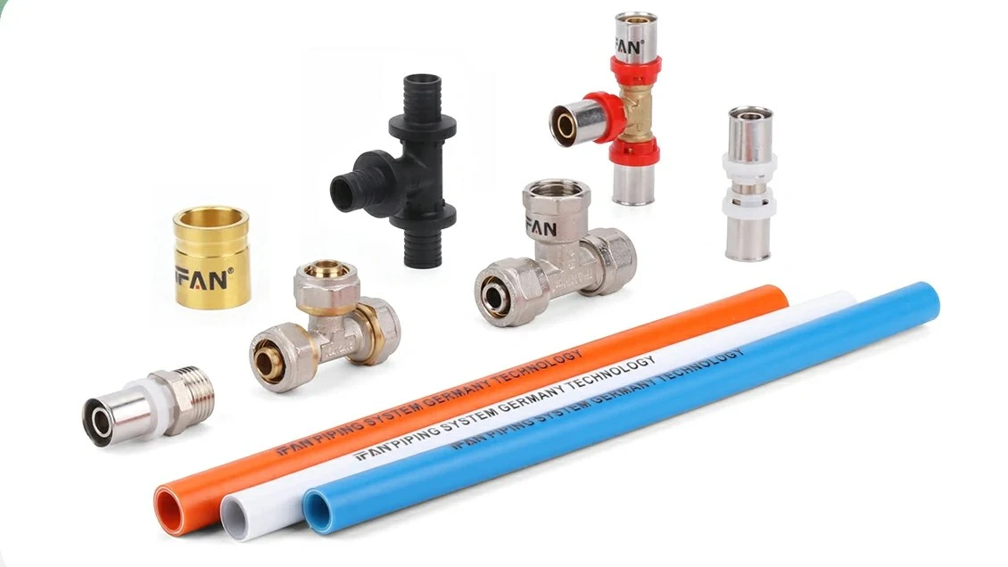 PEX-AL-PEX pipe and brass press fittings laid out together, the pipe-and-fitting system a buyer specifies as one order
